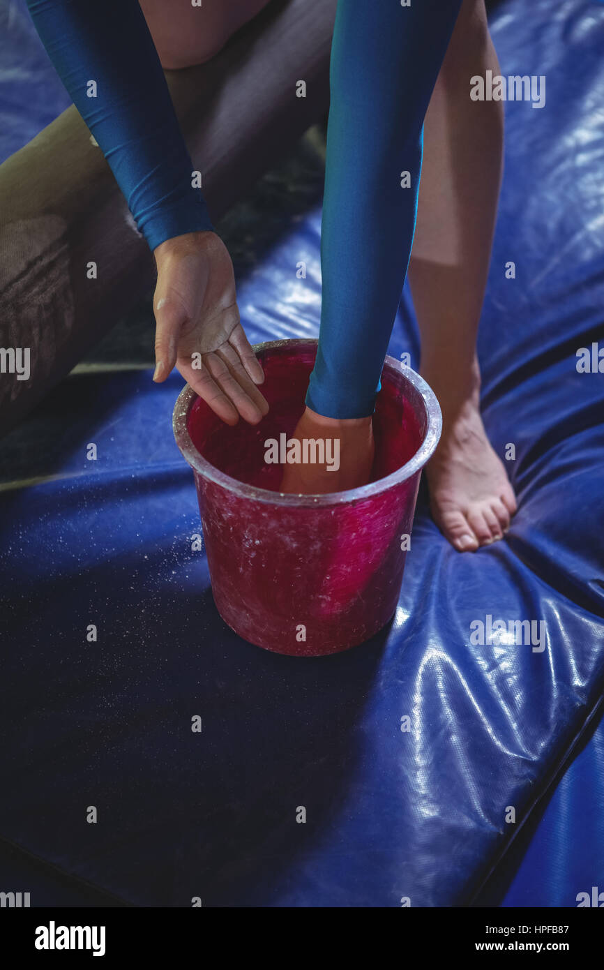 Closeup of a female gymnast applying chalk powder on her hands before