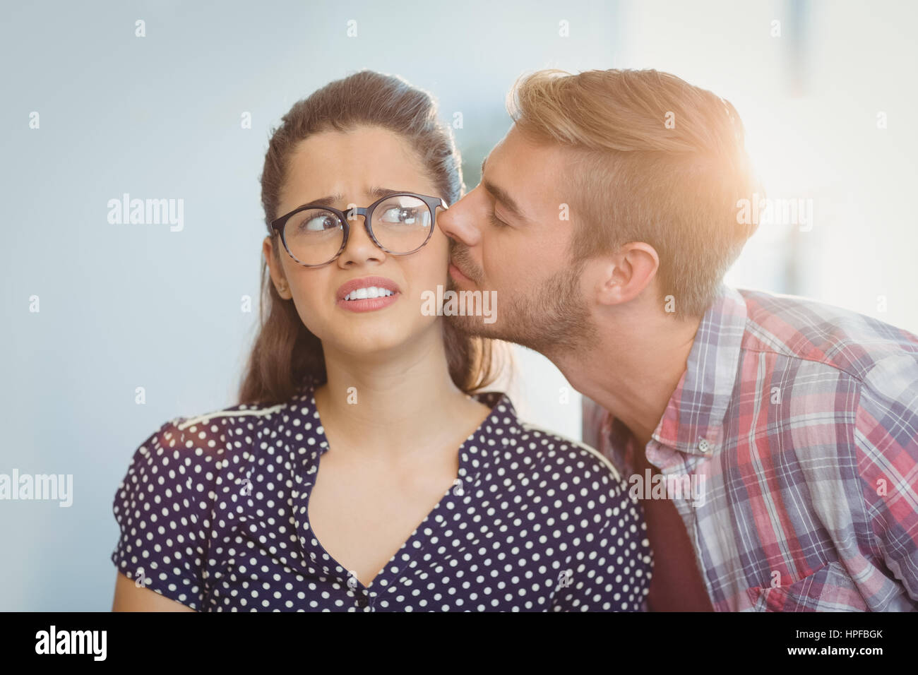 Affectionate man kissing woman in office Stock Photo Alamy