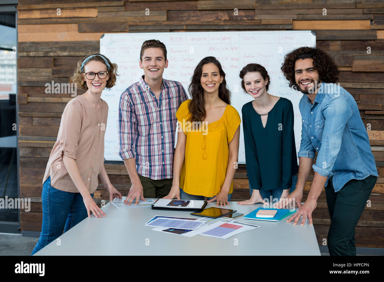 Portrait of smiling business executives standing in office Stock Photo ...