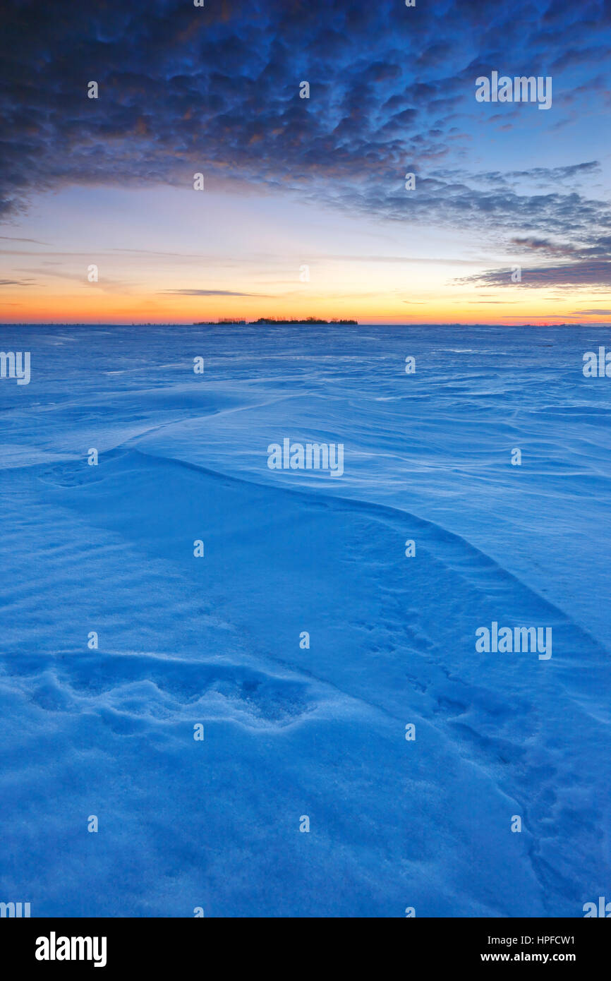 Winter sunset on snow covered fields in Manitoba, Canada Stock Photo