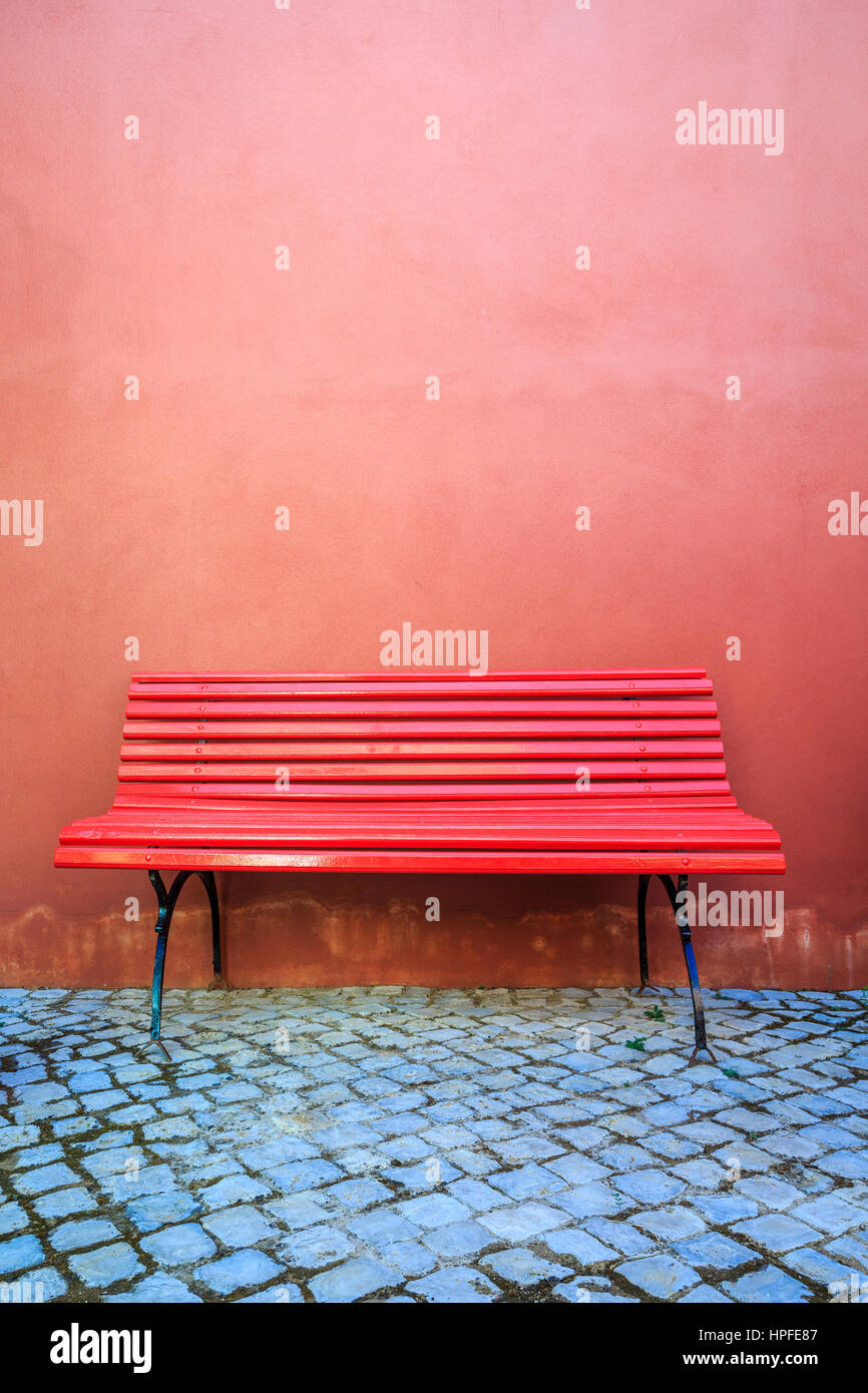 Red bench and red wall, Silves, Algarve, Portugal Stock Photo