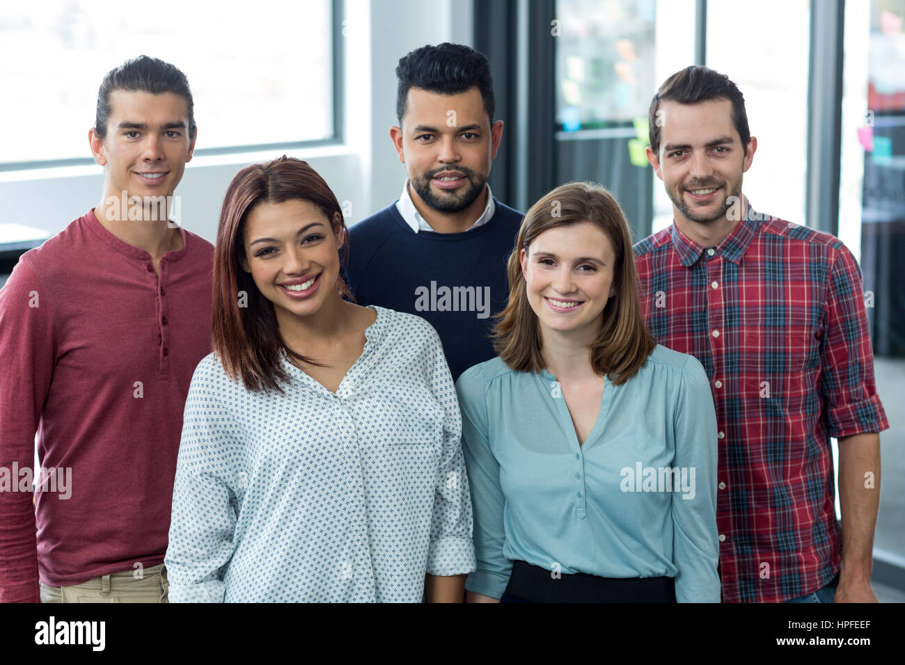 Portrait of businesspeople standing together in office Stock Photo - Alamy