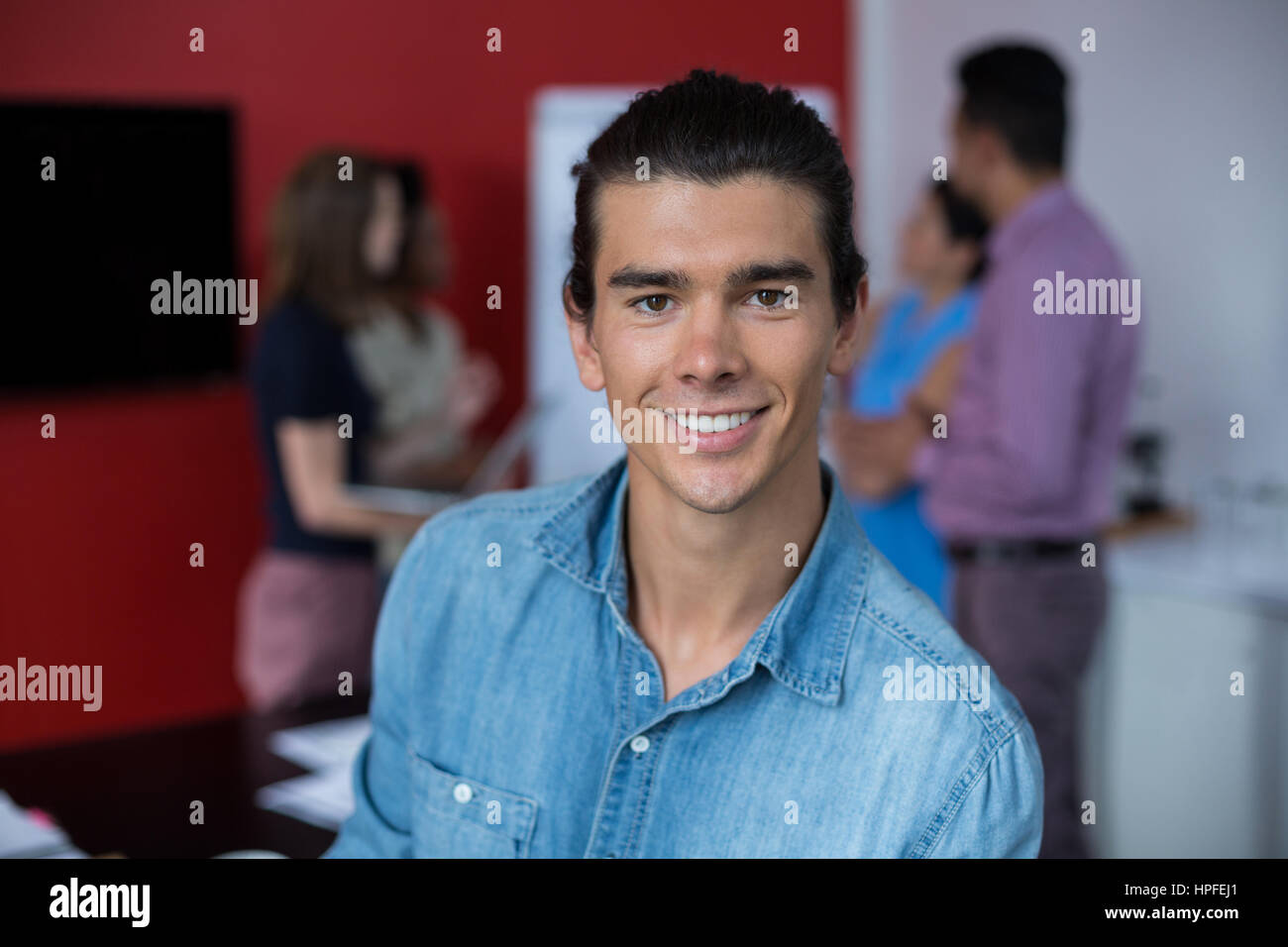 Portrait of smiling business executive at meeting in office Stock Photo ...