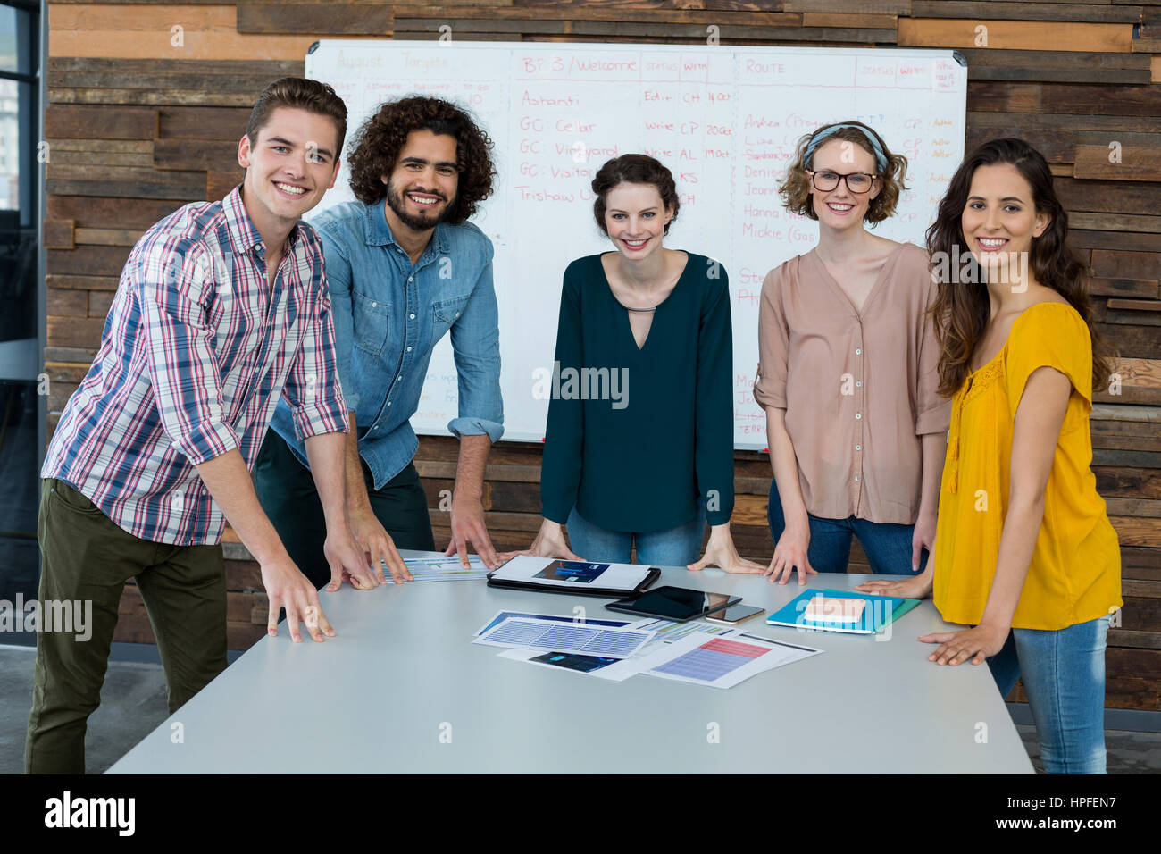 Portrait of smiling business executives standing in office Stock Photo ...