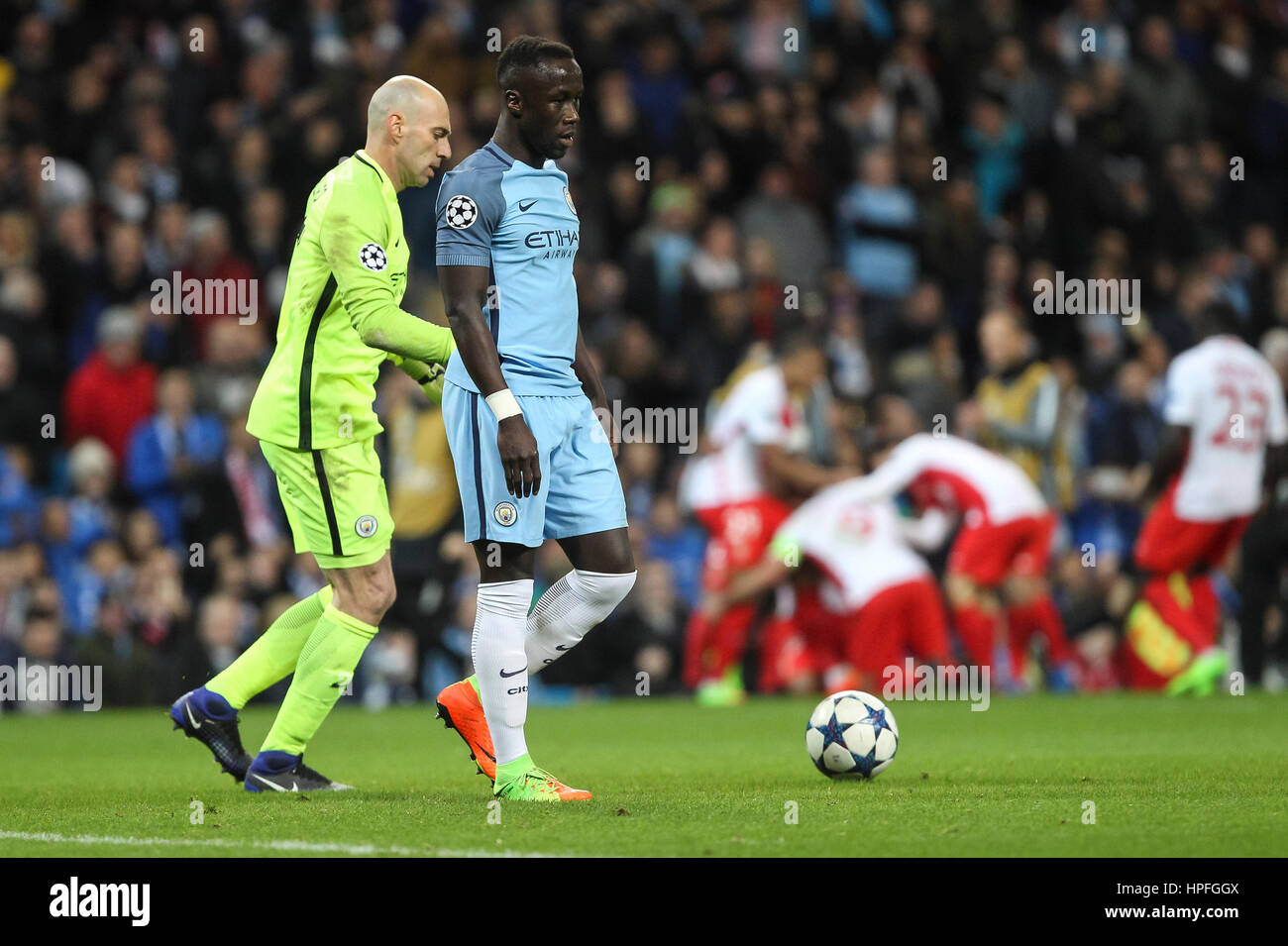 Manchester, UK. 21st Feb, 2017. Bacary Sagna of Manchester City and Claudio Bravo of Manchester City look dejected as Radamel Falcao of Monaco celebrates after scoring his side's third goal during the UEFA Champions League Round of 16 first leg match between Manchester City and AS Monaco at the Etihad Stadium on February 21st 2017 in Manchester, England. Credit: PHC Images/Alamy Live News Stock Photo