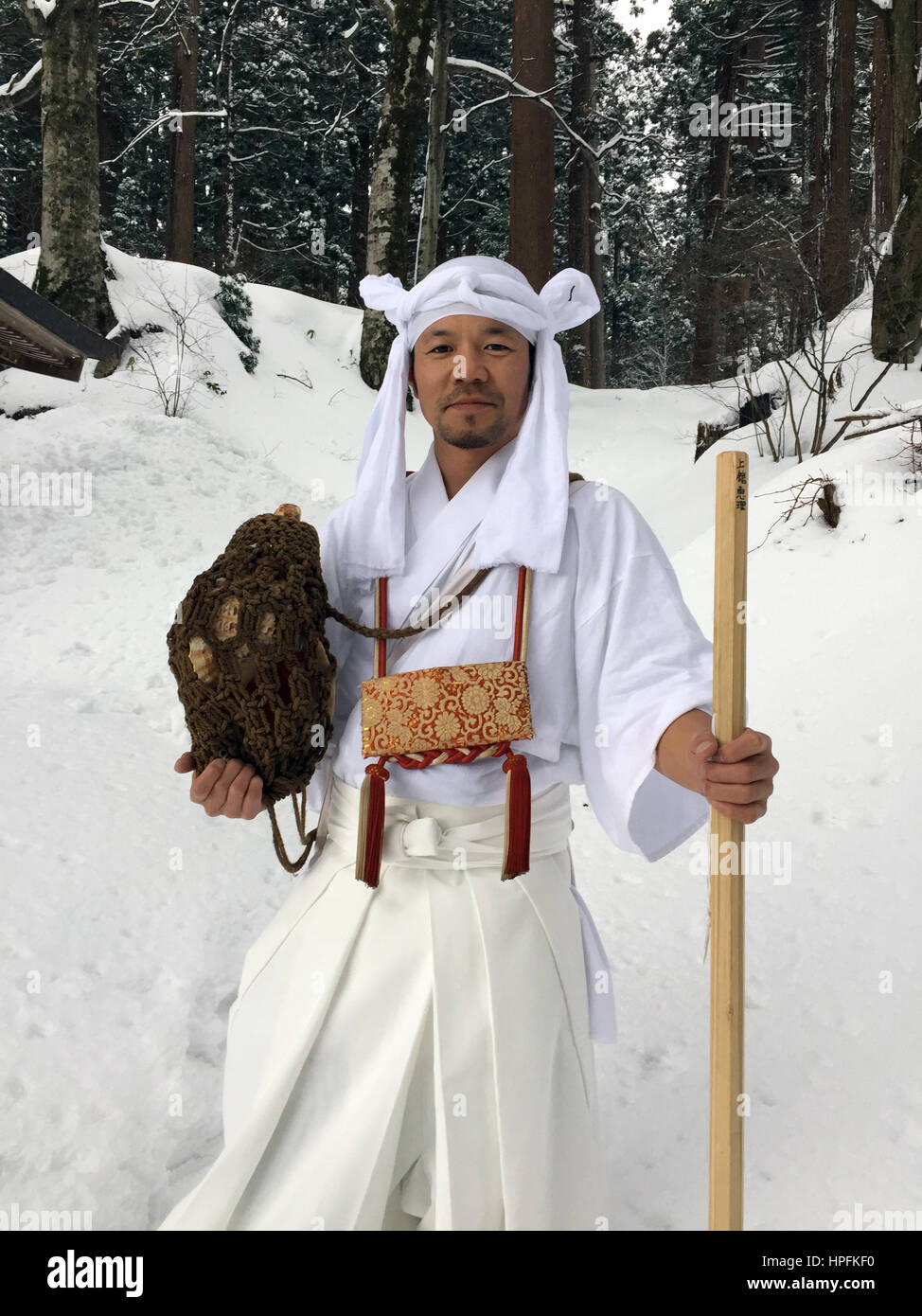 The Japanese Yamabushi mountain ascetic Takehiro Miura holds a conch in snow-covered forest in the Yamagata Province, Japan, 15 February 2017. Monks and members of the laity have retreated into the mountains in the area to live a life immersed in ascetic rituals and prayer for some 1300 years. Photo: Lars Nicolaysen/dpa Stock Photo