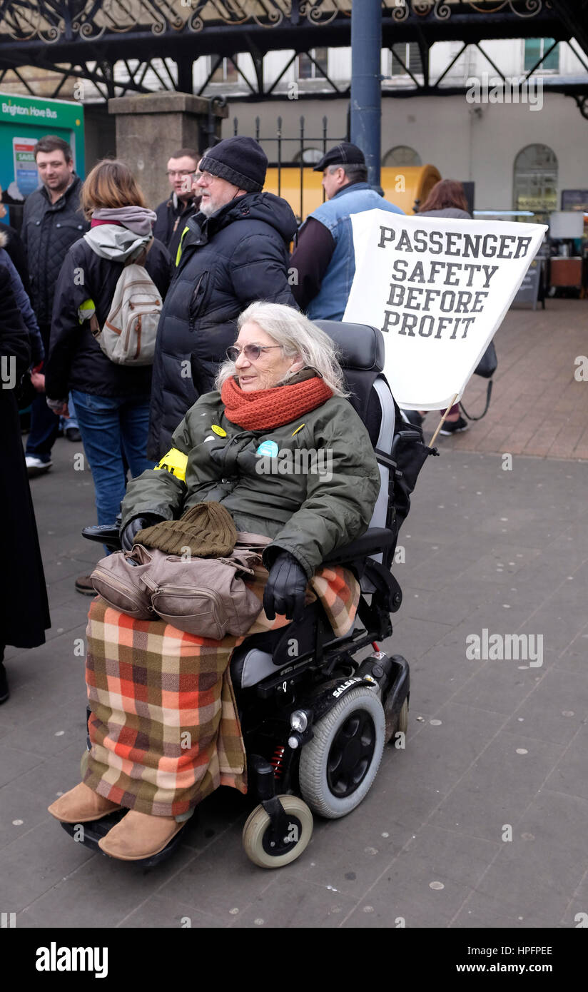 Brighton, UK. 22nd Feb, 2017. Miriam Binder from Disabled People Against Cuts with members of the RMT union on the picket line outside Brighton Railway Station this morning on another day of strike action in the dispute between the management and the unions over driver only trains . The long running dispute which has caused travel disruption in the south east is over Southern Rail management wanting to get rid of conductors on the trains Credit: Simon Dack/Alamy Live News Stock Photo