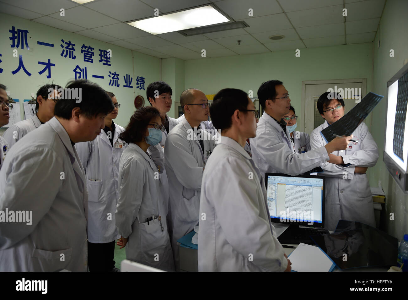 Fuzhou, China's Fujian Province. 17th Feb, 2017. Doctors discuss the feasibility of Tong Xiaoyu's operation at the provincial maternal and child health care hospital in Fuzhou, southeast China's Fujian Province, Feb. 17, 2017. The two-year-old Tong Xiaoyu (anonym) of She ethnic group received a nephroblastoma resection surgery at the hospital on Wednesday. Paediatrics doctors here perform thousands of surgeries every year. Credit: Song Weiwei/Xinhua/Alamy Live News Stock Photo