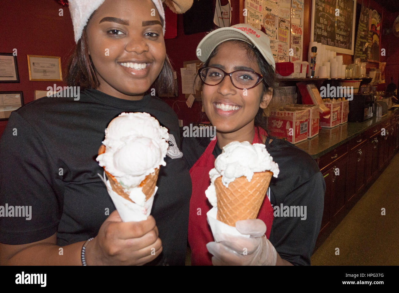 Ice cream scoopers at Grand Ole Creamery Shop holding gigundo cones of peppermint 'Winter Wonderland'. St Paul Minnesota MN USA Stock Photo