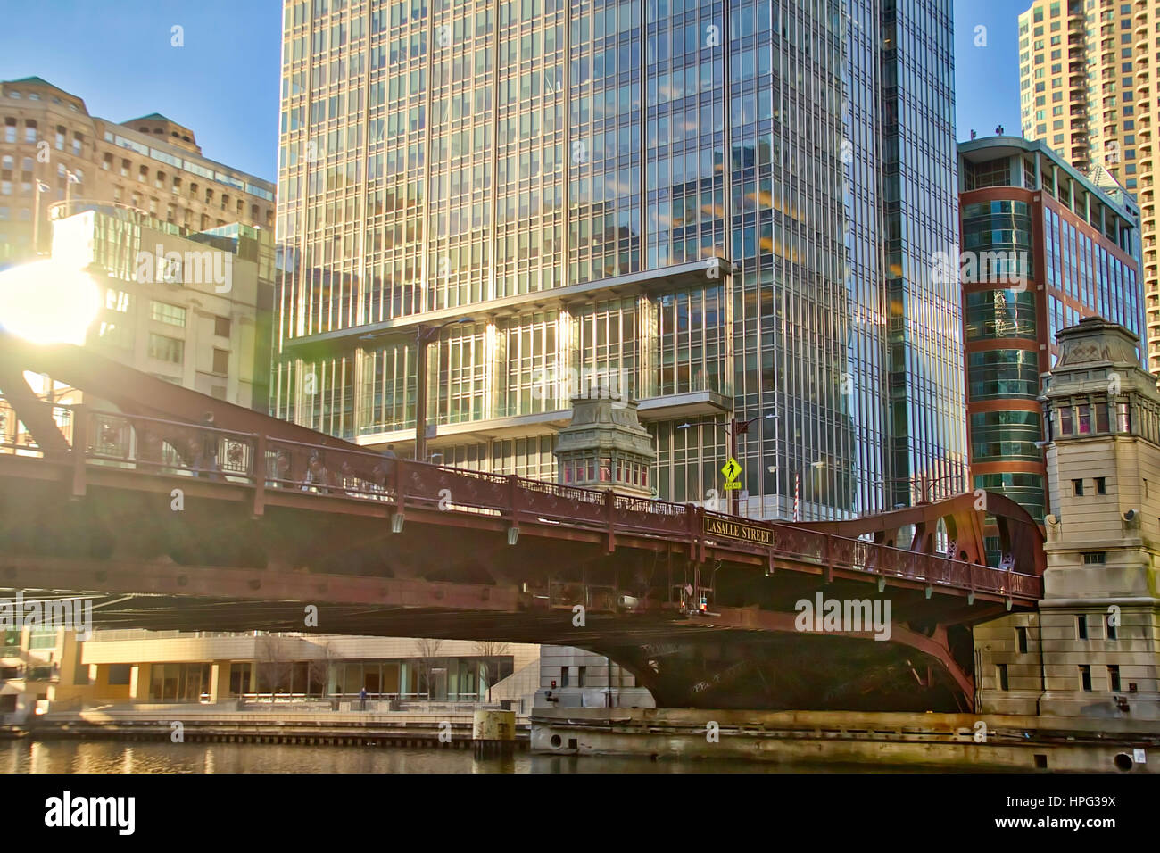 View from Riverwalk in Chicago Loop Business District looking up at Lasalle St Bridge at Sunset Stock Photo