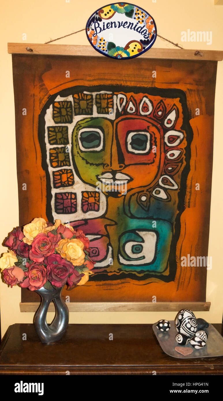 Abstract Hispanic wall hanging in a home with an overhead plaque reading Bienvenidos or welcome. Downers Grove Illinois IL USA Stock Photo