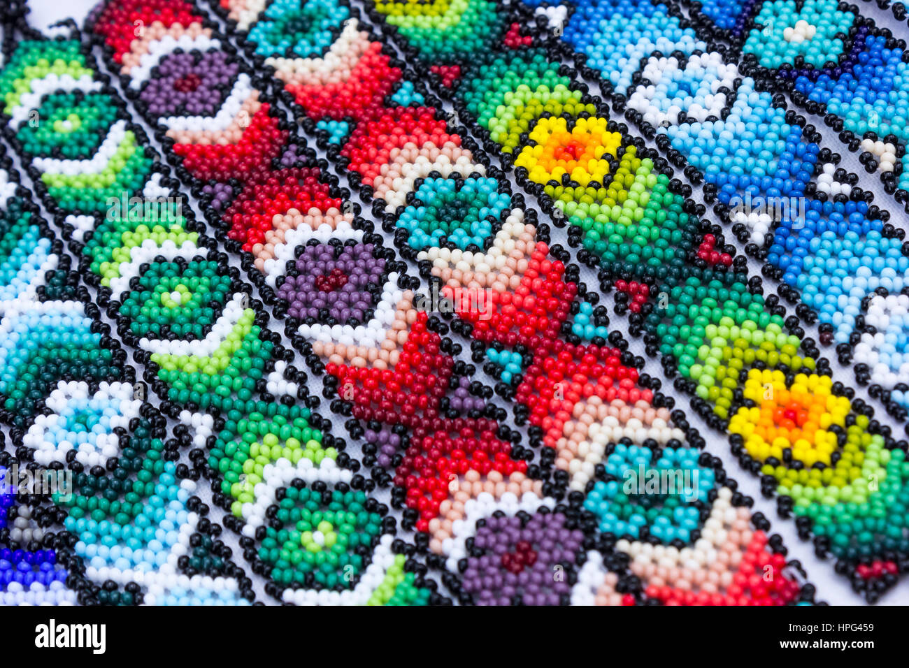 Huichol art. Beaded bracelets and jewelry. Colorful patterns. Background Stock Photo