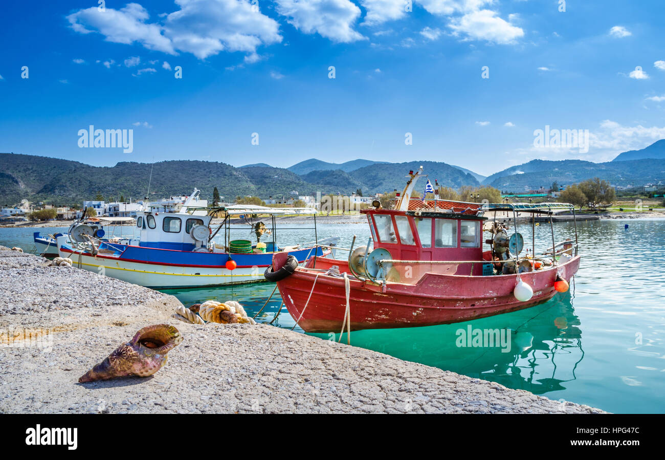 Big shell in front of traditional fishing boats, Crete, Greece. Stock Photo