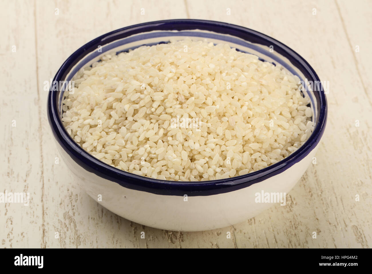 Local Rice Heap Raw rice heap in the bowl - ready for cooking Stock Photo - Alamy