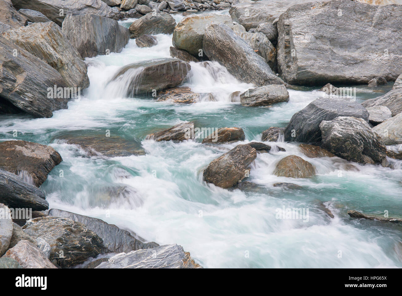 Haast Pass, Mount Aspiring National Park, West Coast, New Zealand. The foaming waters of the Haast River tumbling over rocks at the Gates of Haast. Stock Photo