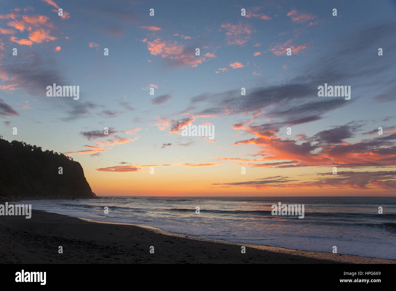 Okarito, Westland Tai Poutini National Park, West Coast, New Zealand. Colourful sky over the Tasman Sea, dusk. Stock Photo