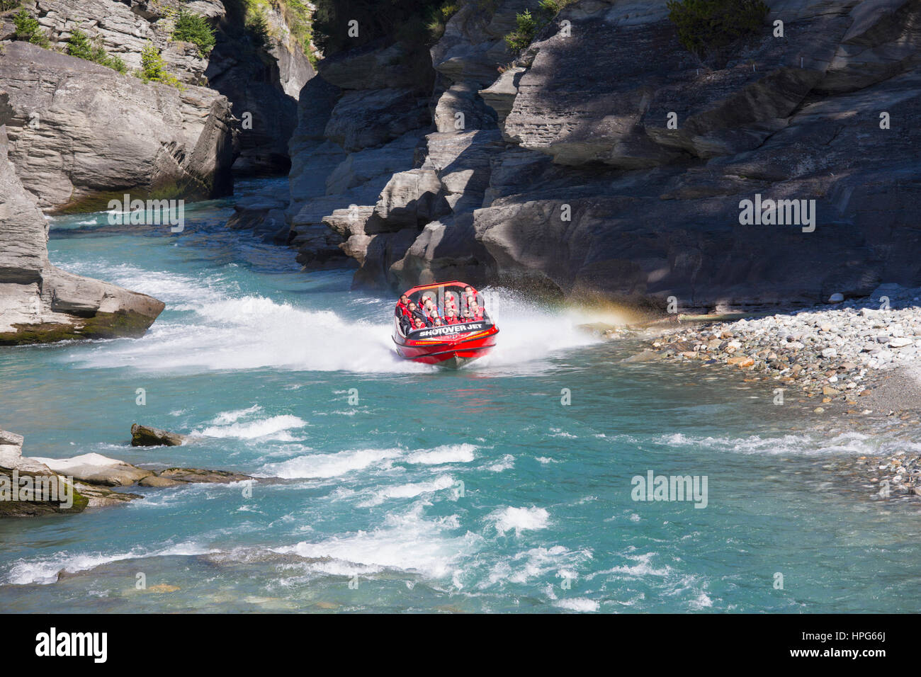 Queenstown, Otago, New Zealand. Shotover Jet boat emerging from narrow canyon on the Shotover River. Stock Photo