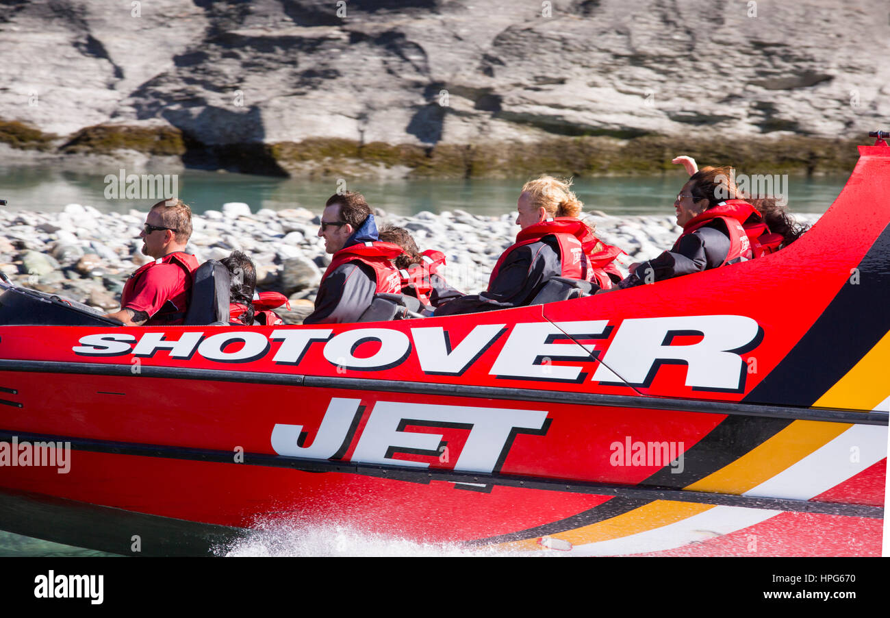 Queenstown, Otago, New Zealand. Shotover Jet boat speeding across the Shotover River. Stock Photo