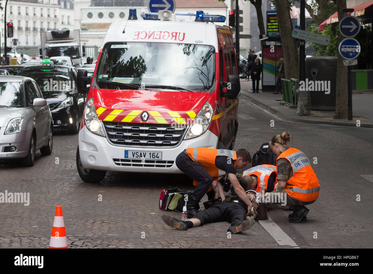 France Paris Emergency Firemen Service In Intervention On An Accident In A Street Wounded Person On The Ground Stock Photo Alamy