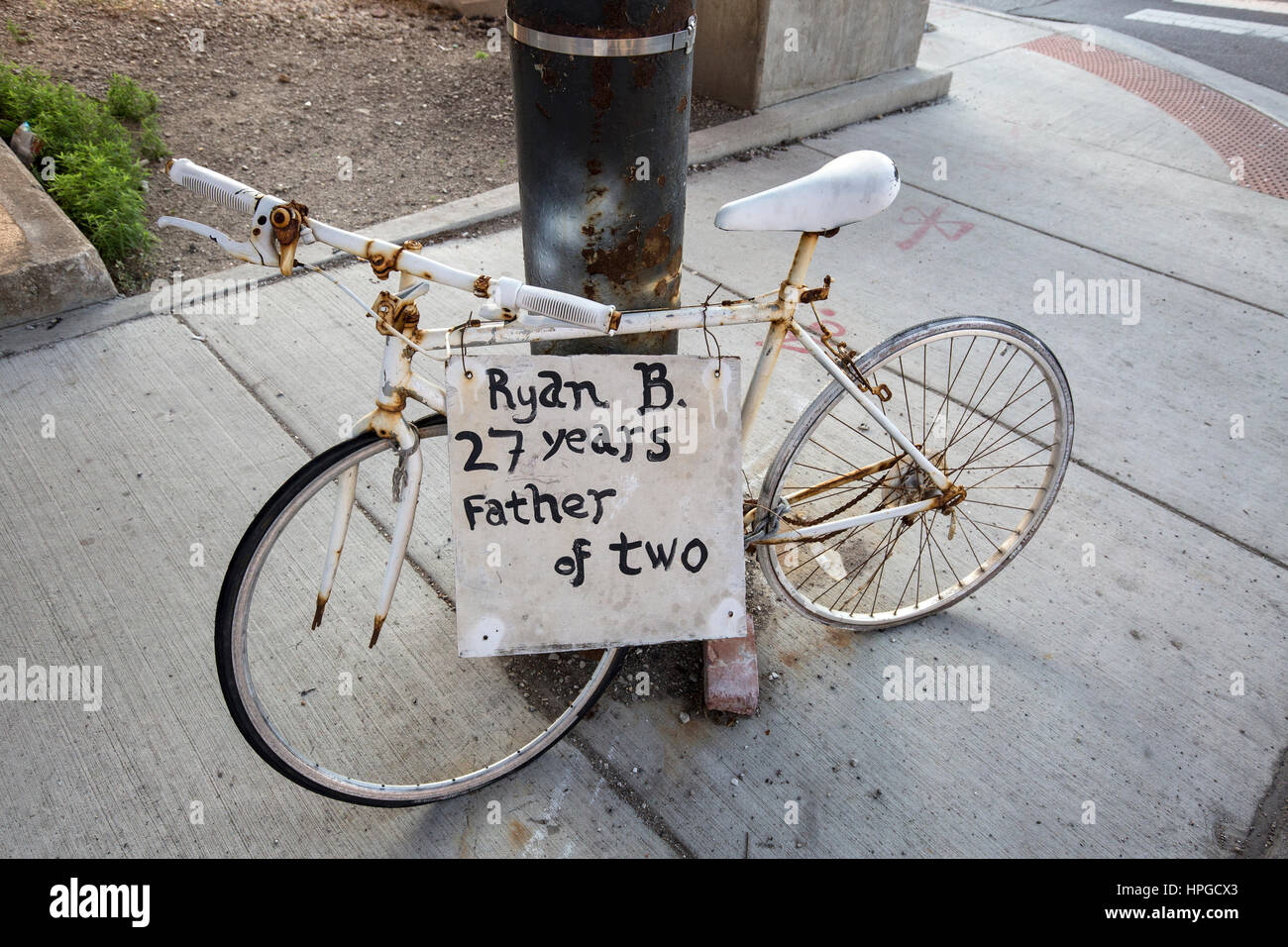 Ghost bike in Chicago's Chinatown district memorializing a man killed in a bicycle accident. Stock Photo