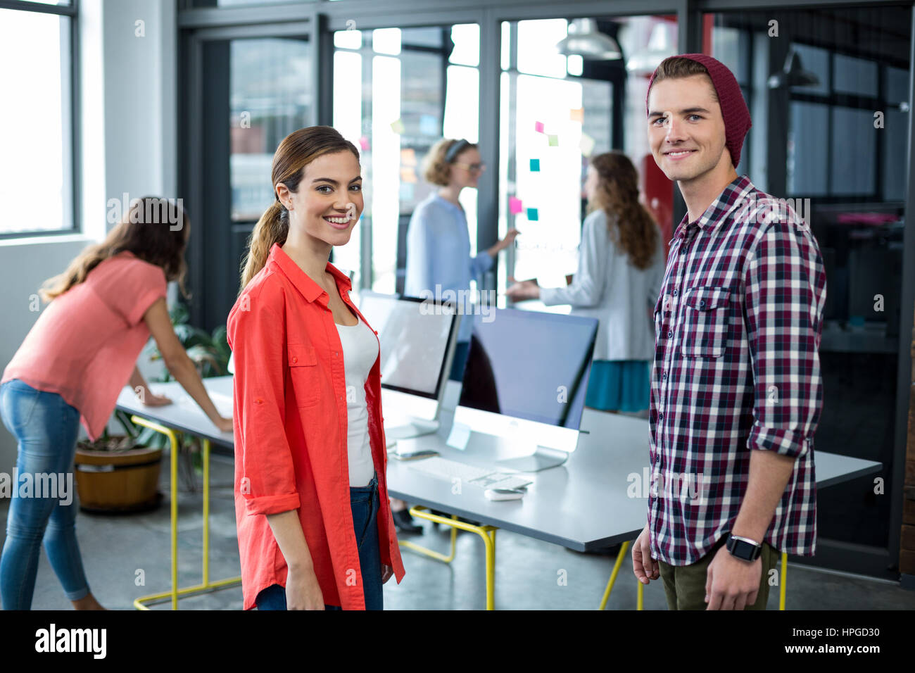 Portrait of smiling business executives standing in office Stock Photo ...
