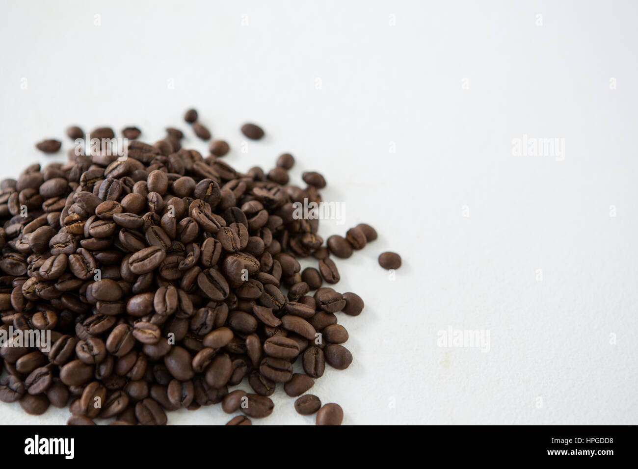 Pile of roasted coffee beans on white background Stock Photo - Alamy