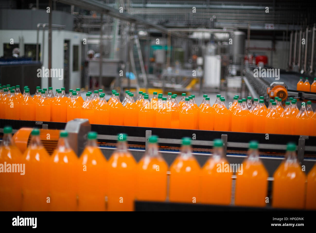Bottle of juice processing on production line in bottle factory Stock