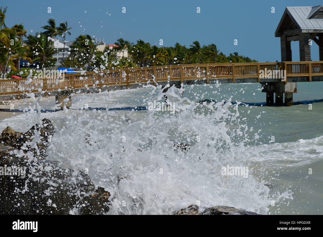 Waves crashing against the rocks at south beach, Key West Stock Photo