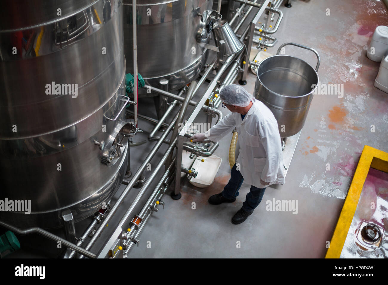 Factory engineer monitoring storage tank in bottle factory Stock Photo