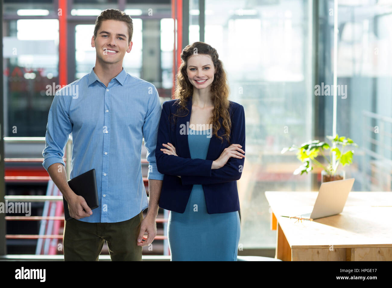 Portrait of smiling business executives standing in office Stock Photo ...