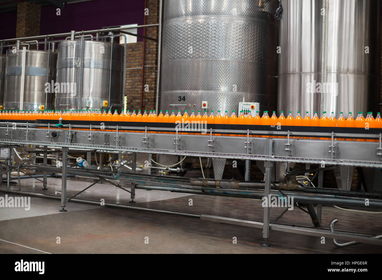 Cold drink bottles on the production line at drinks production factory