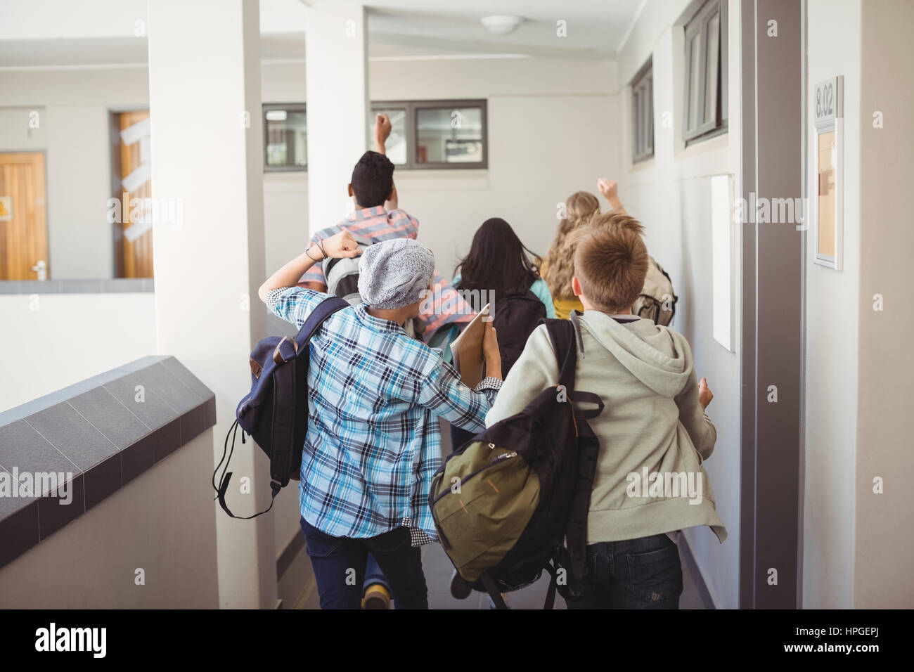 Group of classmate running in corridor at school Stock Photo - Alamy