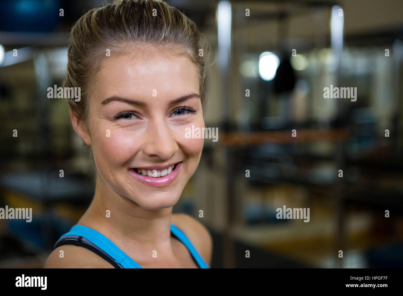 Portrait of smiling fit woman in fitness studio Stock Photo - Alamy