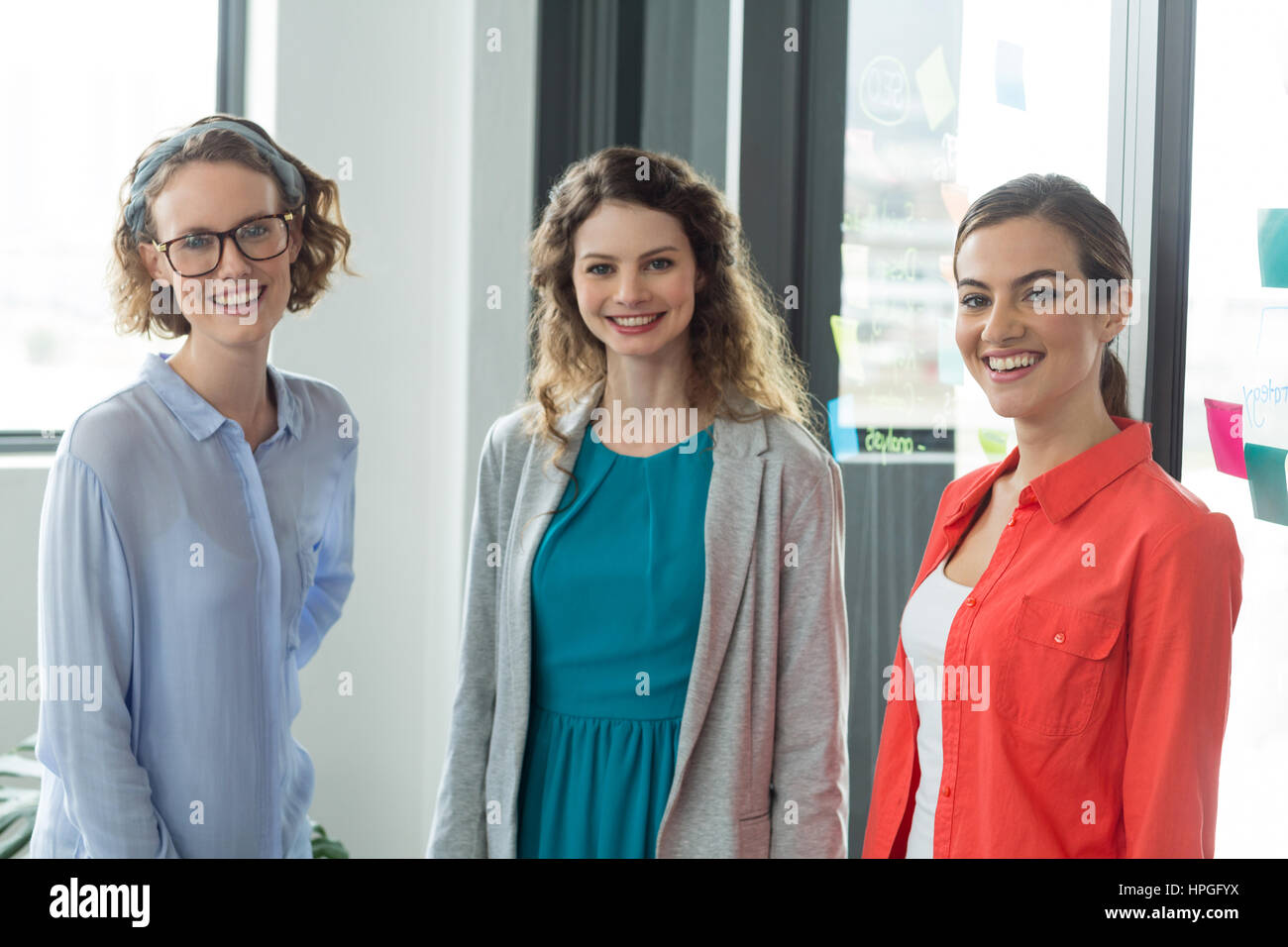Portrait of smiling business executives standing in office Stock Photo ...