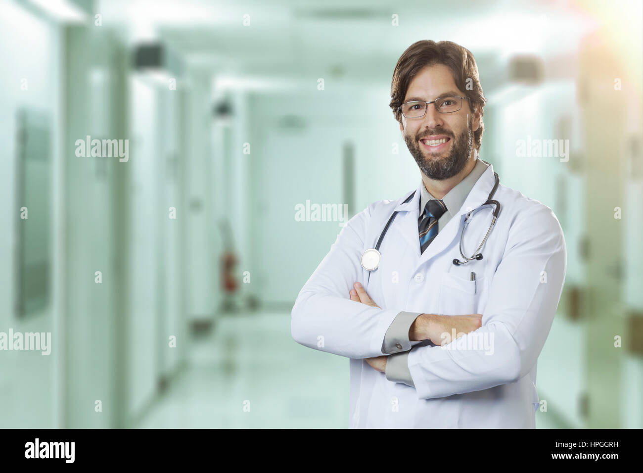 Male doctor at a hospital smiling Stock Photo - Alamy