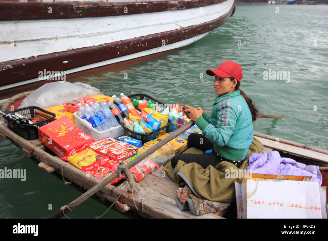 A Fisherwoman sells products to tourists in Halong Bay, Vietnam Stock Photo
