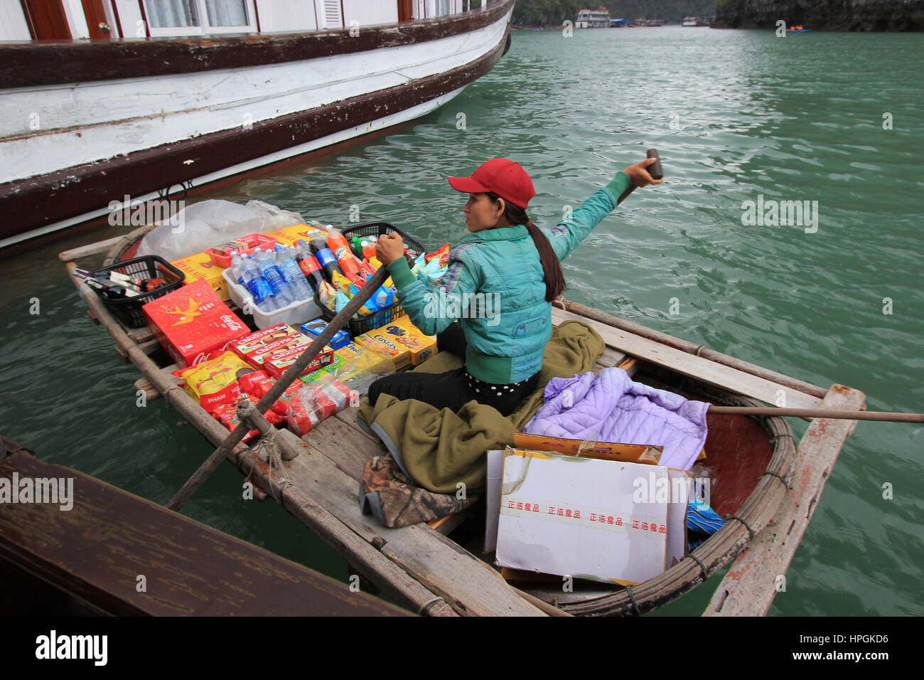 A Fisherwoman sells products to tourists in Halong Bay, Vietnam Stock Photo