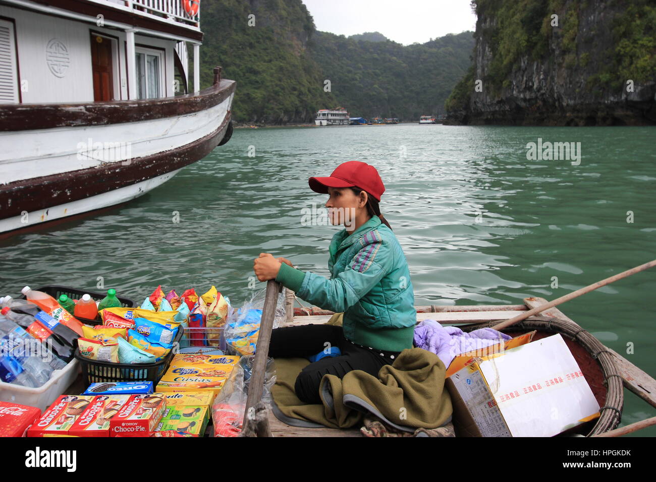 A Fisherwoman sells products to tourists in Halong Bay, Vietnam Stock Photo