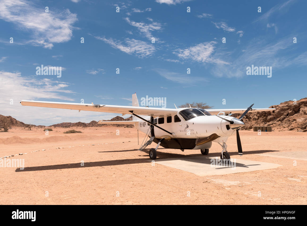 A Cessna 208 parked on the airstrip serving the Wilderness Safaris Hoanib Skeleton Coast Camp. Stock Photo