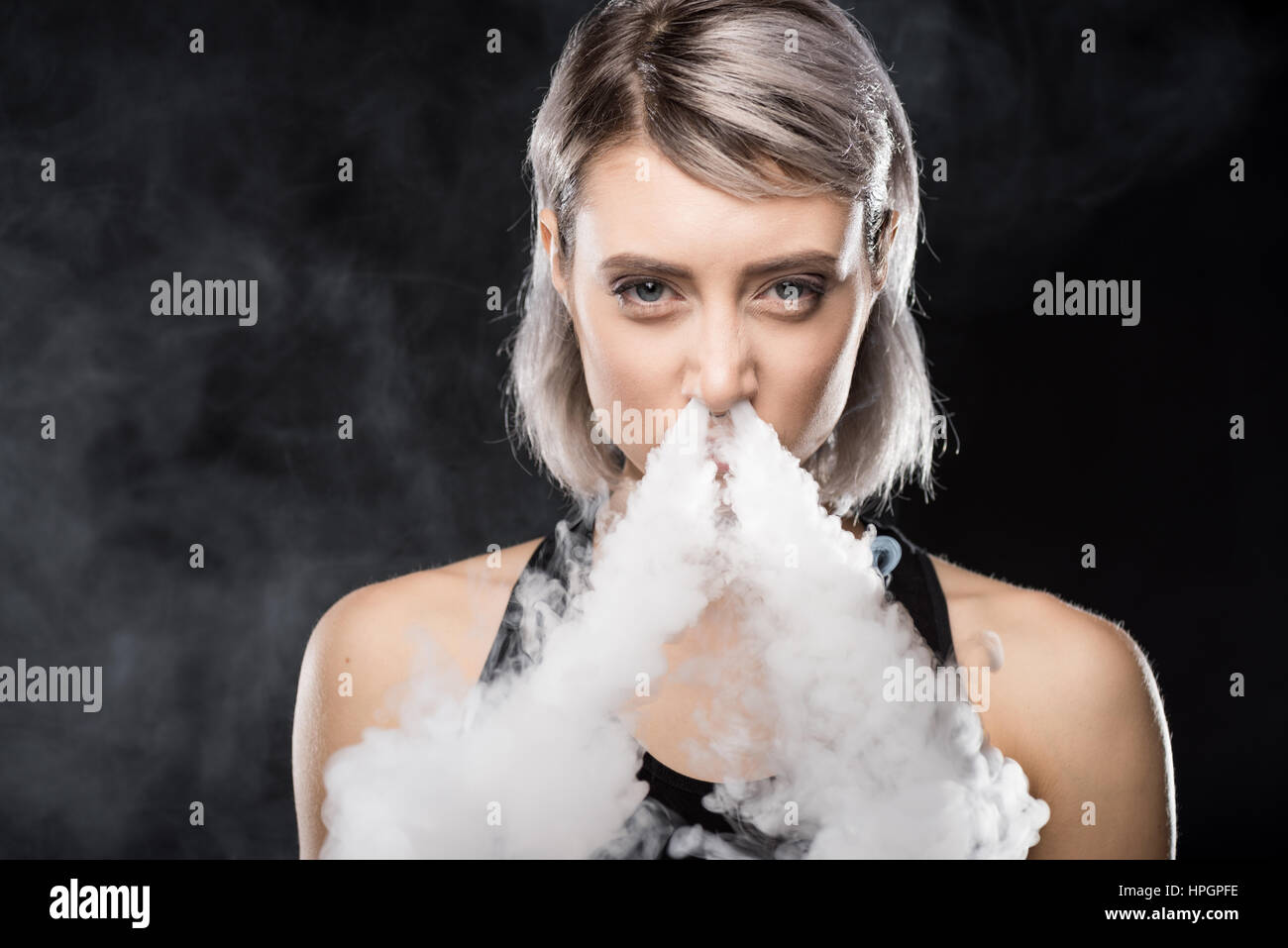 blue lotus vape juice woman vaping and blowing smoke of electronic cigarette from nose Stock  Photo