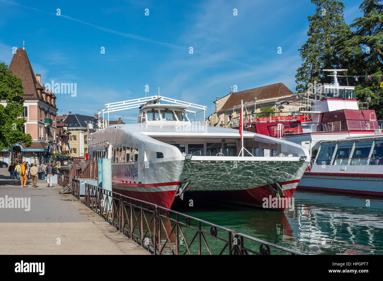 Annecy, France - May 25, 2016: Tourist excursion boats are moored at the pier seen during the spring sunny day in Annecy, Haute Savoie, French Alps, F Stock Photo