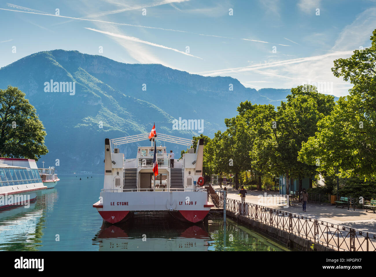 Annecy, France - May 25, 2016: Tourist excursion boats are moored at the pier seen during the spring sunny day in Annecy, Haute Savoie, French Alps, F Stock Photo