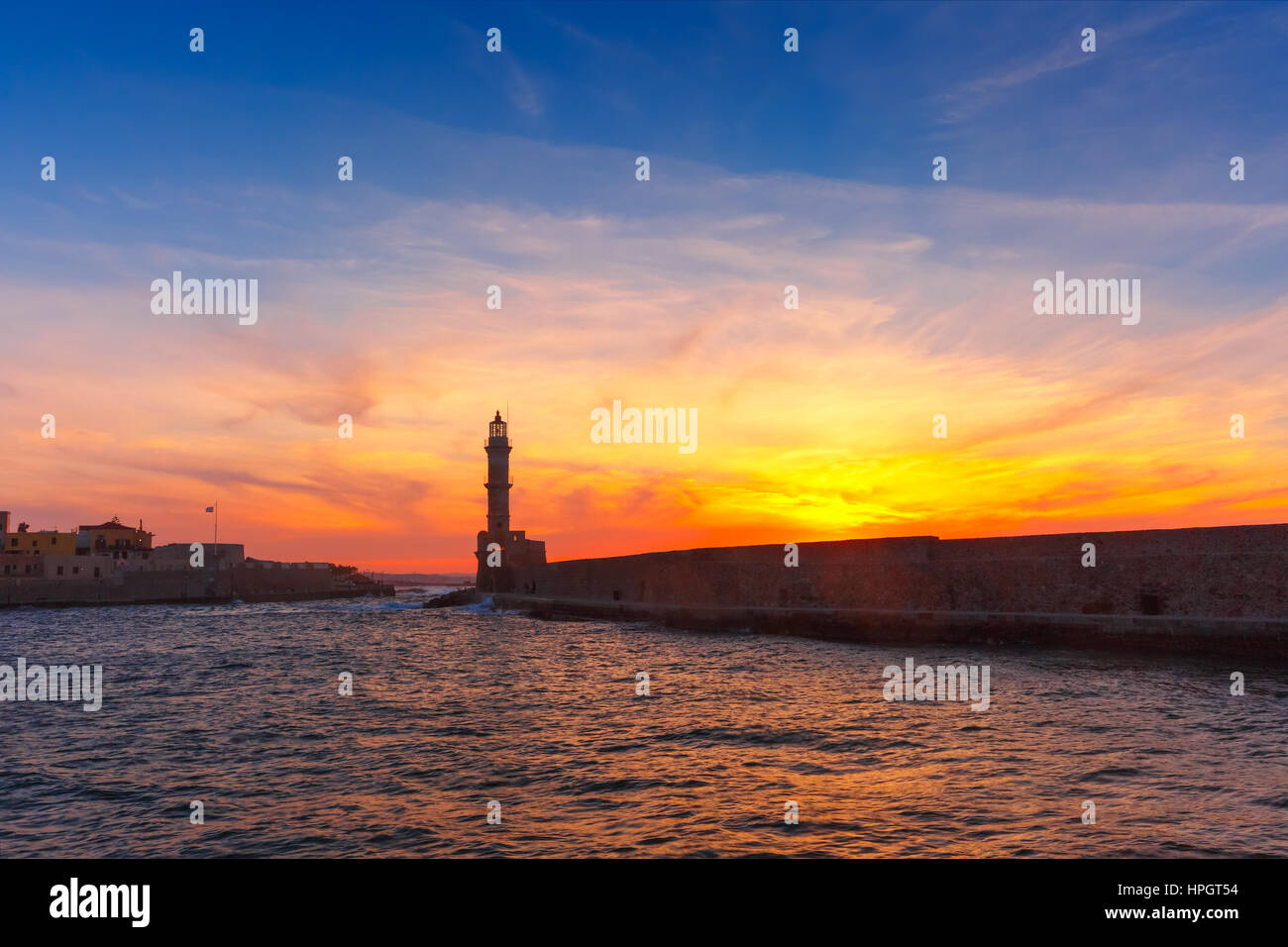 Lighthouse in old harbour of Chania at dawn, Crete, Greece Stock Photo