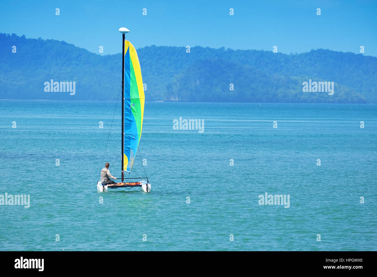 colorful sailboat and blue water Stock Photo - Alamy