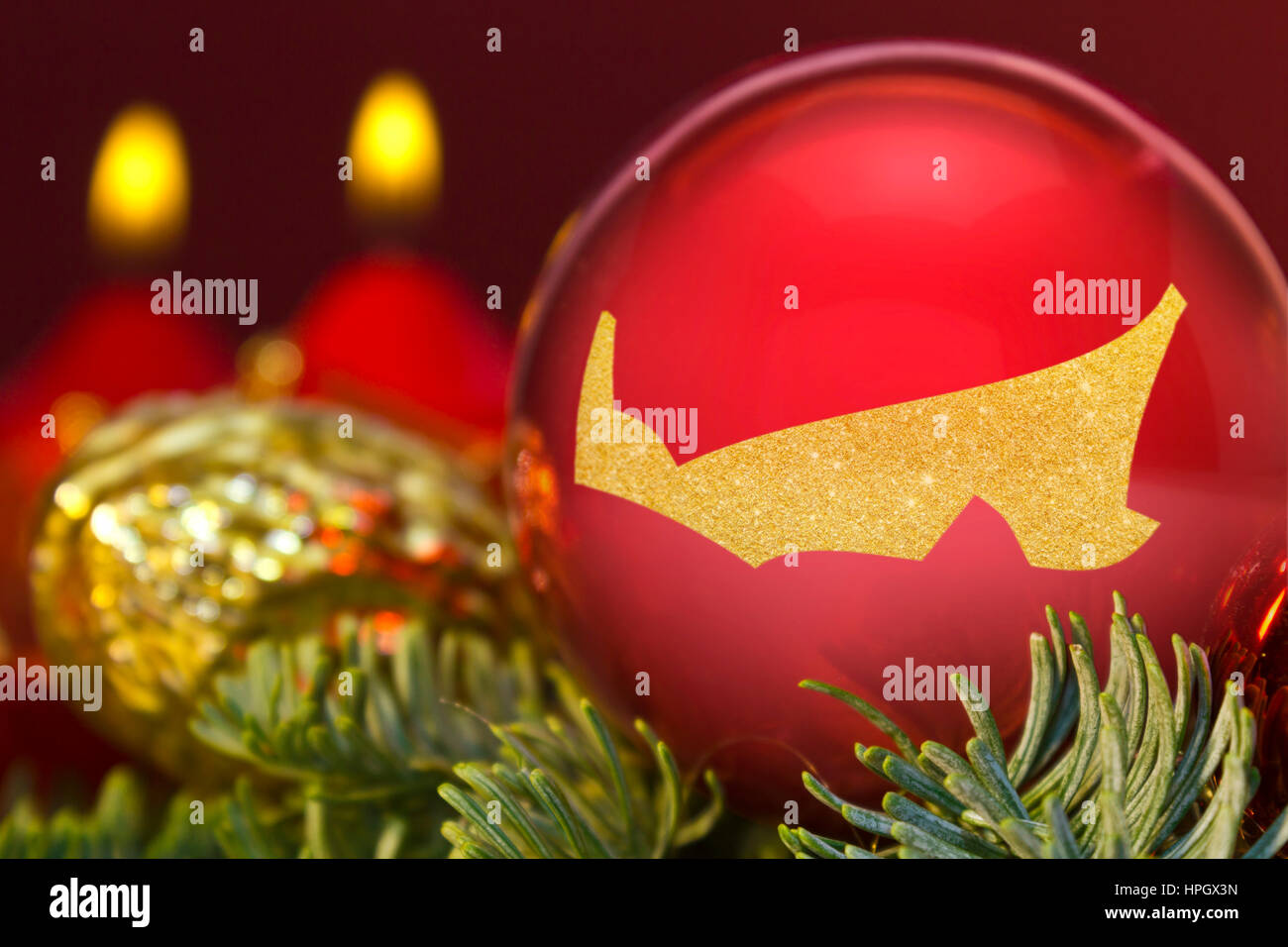 A glossy red bauble with the golden shape of Prince Edward Island.(series) Stock Photo
