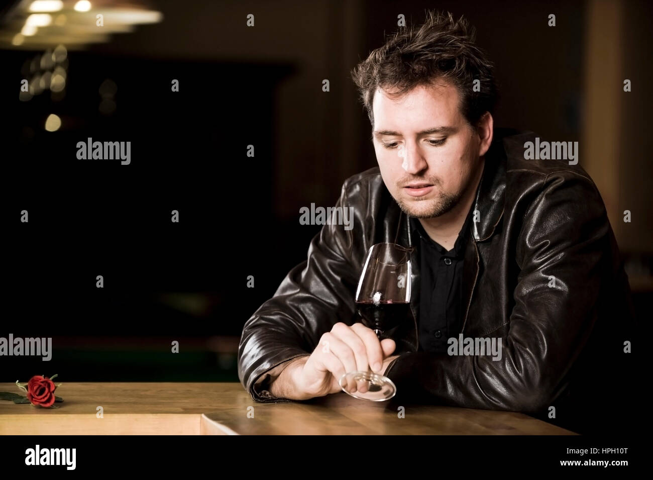 Model released , Junger Mann mit Rotweinglas - man withred wine Stock Photo