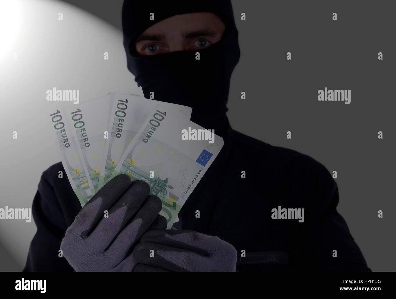 Model released , Symbolbild, Einbrecher mit Geld - symbolic for burglar Stock Photo