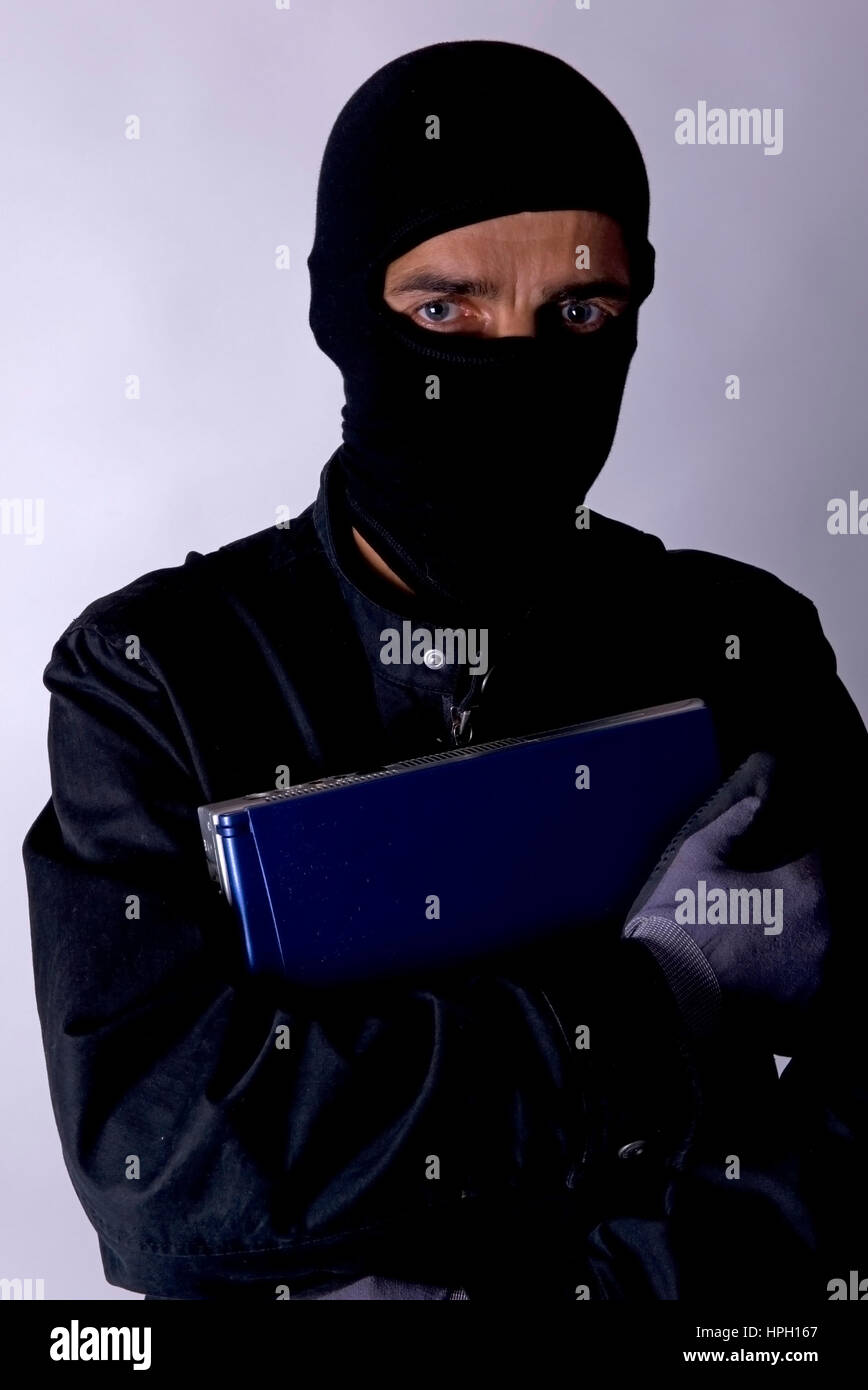 Model released , Symbolbild Datenklau, Einbrecher mit laptop - symbolic for data piracy Stock Photo