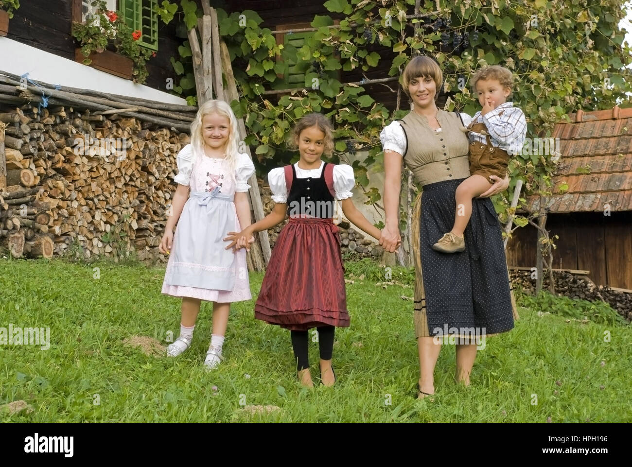 Model released , Baeuerin mit Kindern am Bauernhof - farmwoman with children Stock Photo