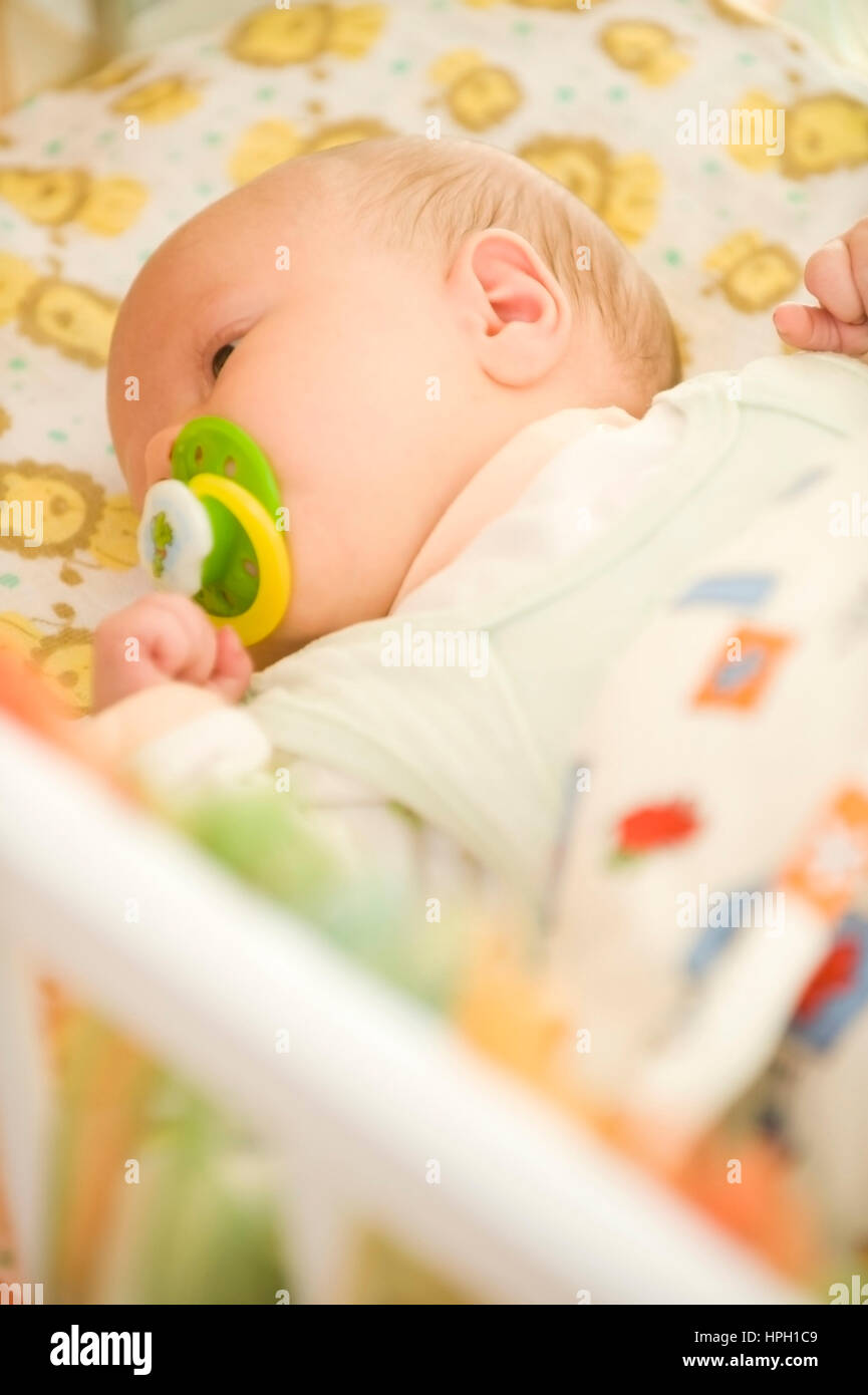 Model released , Baby liegt im Kinderbett - baby in children bed Stock Photo
